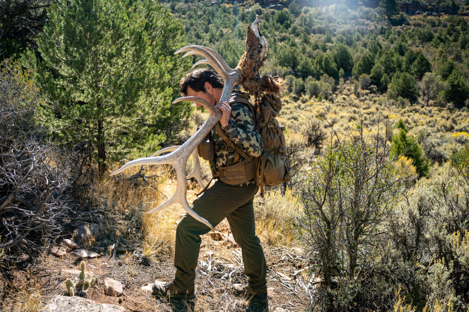 Loaded hunting pack and bow staged for a western archery hunt